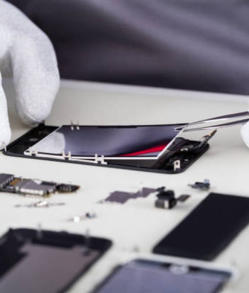 Close-up Of Repairman Disassembling Smartphone With Tweezers